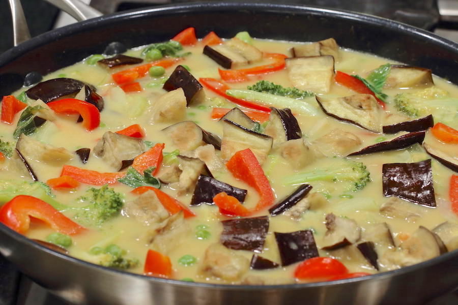 Vegetarian Thai Green Curry cooking in a large skillet