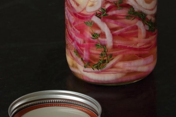Pickled Red Onion in jar with fresh thyme