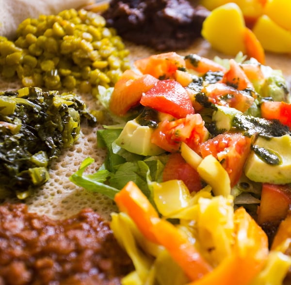 Ethiopian vegan platter including Atakilt Wat served on Injera flatbread