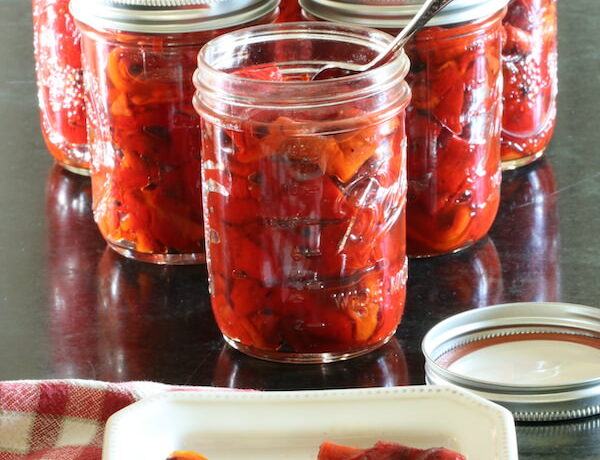 Roasted red peppers in jars and on plate