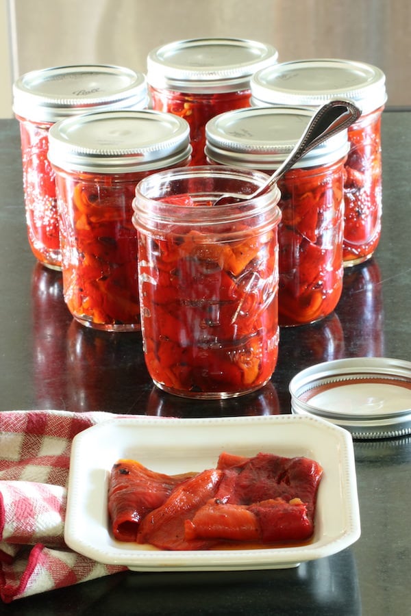 Roasted red peppers in jars and on plate
