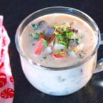 Clear glass soup cup filled with vegan clam chowder