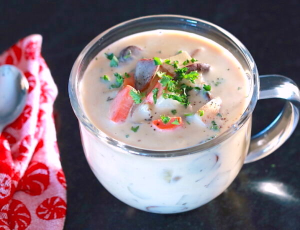 Clear glass soup cup filled with vegan clam chowder