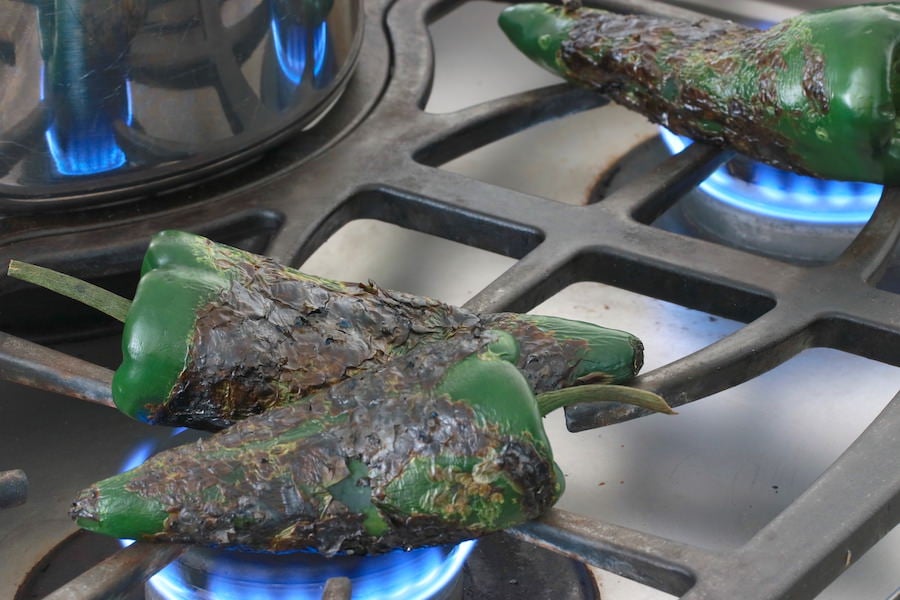 Poblano peppers roasting on gas stove