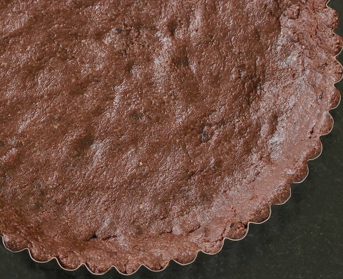 Cacao crust pressed into a tart pan