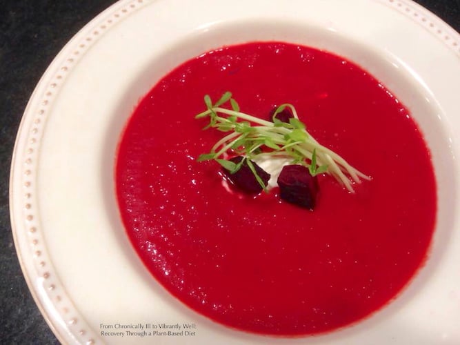 Blended Borscht in a large bowl – garnished with a bit of roasted beets, yogurt, and sprouts