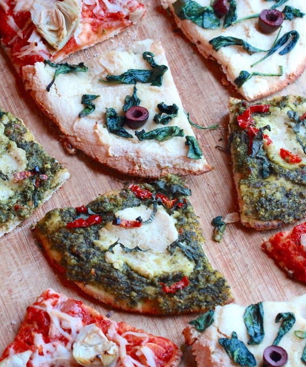 Three varieties of gluten-free vegan pita pizzas cut into wedges