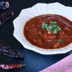 Bowl of Chili Recipe Vegan with arrangement of dried chile peppers