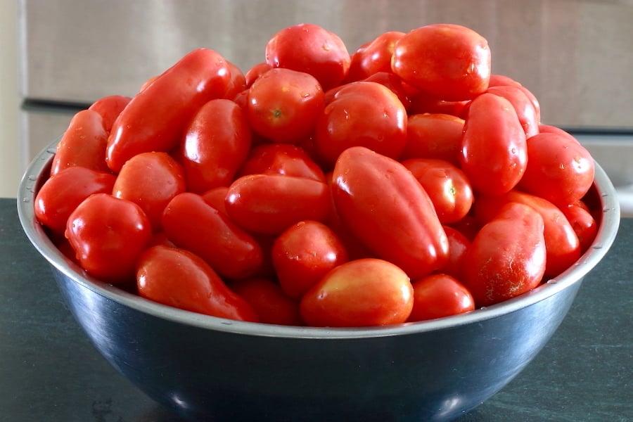 Roma tomatoes in a stainless steel bowl