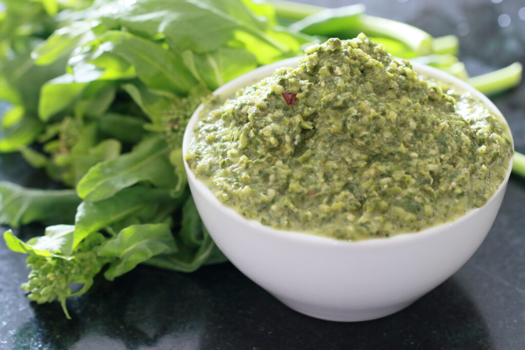 Bowl of Broccoli rabe with a small bunch or rabe arranged to the side