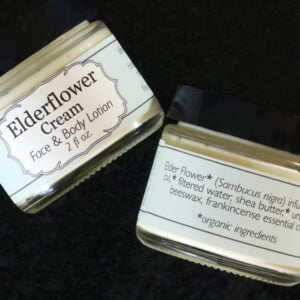 View of front and back labels of open jar of Elderflower Cream
