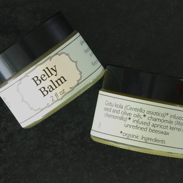 View of front and back labels of 2 oz jar of hand made Belly Balm