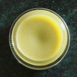 Overhead view of open jar of belly balm