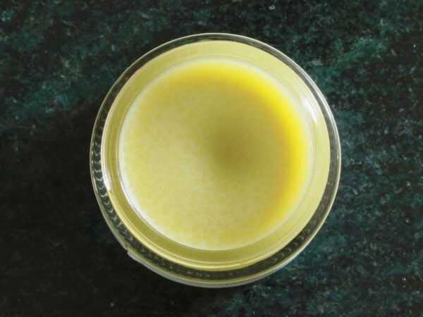 Overhead view of open jar of belly balm